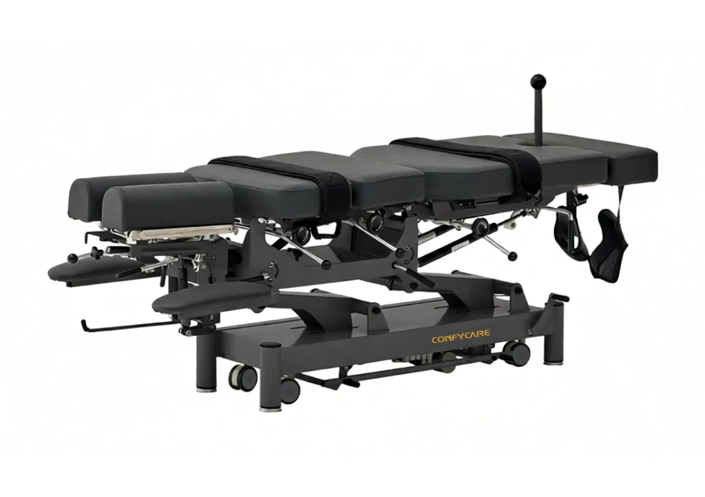 A professional grey Confycare flexion distraction chiropractic table with adjustable segments and ankle straps, used for spinal decompression and treating disc herniations.